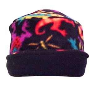 May include: A black fleece beanie with a colorful pattern of abstract shapes and designs. The beanie has a fold-over cuff.