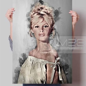 May include: A portrait print of a woman with blonde hair in a bouffant style, wearing a light-coloured off-the-shoulder top. The artwork has a watercolour effect with grey and white tones. The print is held by a person.