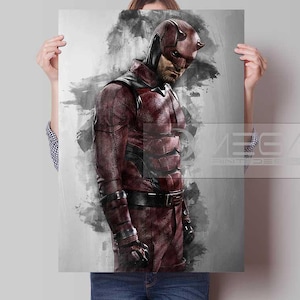 May include: A rectangular poster featuring a dark red, textured superhero suit with a matching horned mask. The character stands against a gray, watercolor-style background with black ink splatters. The text MEGA PRINT DESIGN is visible.