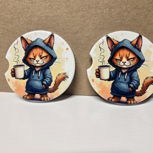 May include: A set of three ceramic mugs with a speckled, matte finish. The mugs are in shades of cream, light gray, and dark gray. Each mug has a simple, minimalist design, perfect for coffee or tea.