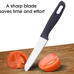 May include: A sharp kitchen knife with a dark gray handle and a silver blade, resting on a wooden surface next to two tomato halves. The text "A sharp blade saves time and effort" is displayed above the knife.
