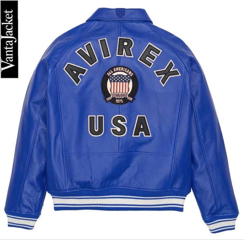 May include: A vibrant blue leather jacket with the word "AVIREX" arched across the back in white lettering. Below the word "AVIREX" is a patch with the words "ALL AMERICANS" and "ESTABLISHED 1975". The word "USA" is below the patch.