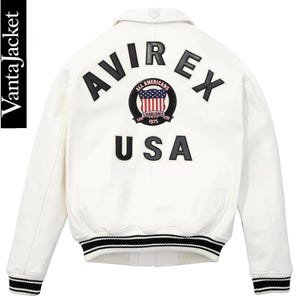 May include: White jacket with black and red accents. The back features the word "AVIREX" above a circular emblem with the words "ALL AMERICANS ESTABLISHED 1975" and a USA flag design. Below the emblem is the word "USA".
