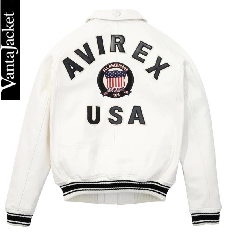 May include: White jacket with black and red accents. The back features the word "AVIREX" above a circular emblem with the words "ALL AMERICANS ESTABLISHED 1975" and a USA flag design. Below the emblem is the word "USA".