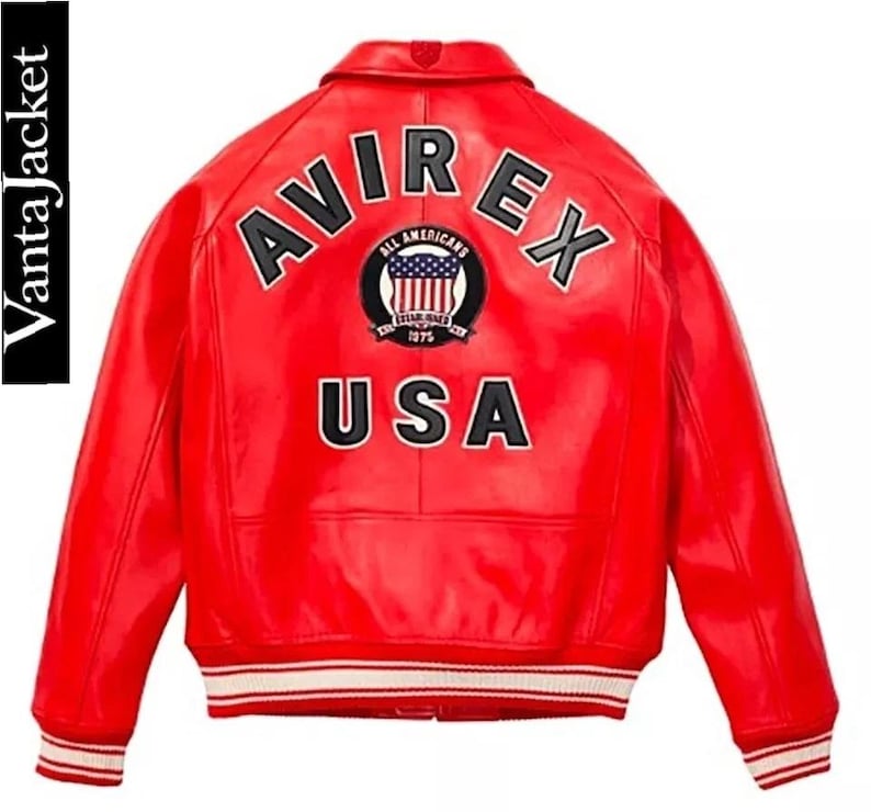 May include: A vibrant red leather jacket with the word "AVIREX" arched across the back in white lettering. Below the name is a circular patch with the words "ALL AMERICANS" and "ESTABLISHED 1975" surrounding a US flag design. The word "USA" is printed below the patch.