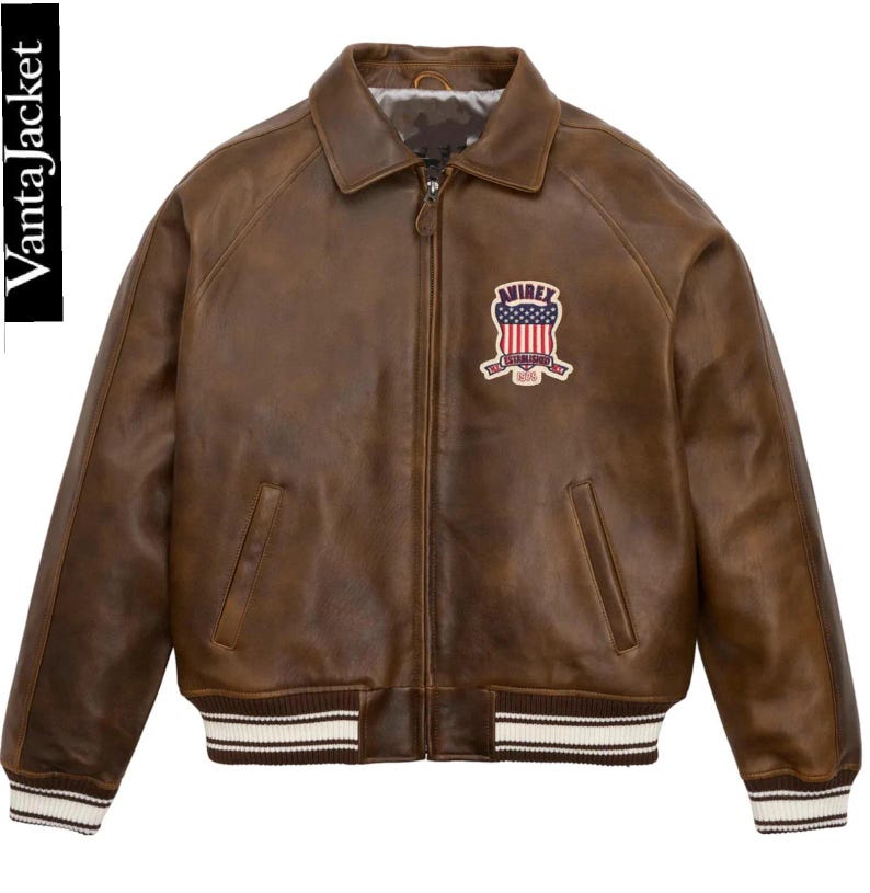 May include: Brown leather jacket with a zip-up front, collar, and a patch on the chest. The jacket has a ribbed hem and cuffs with white stripes. The brand name "VantaJacket" is printed on the left side.