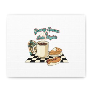May include: Canvas art print featuring a diner scene with a jukebox, coffee mug, slice of pie, and a hot dog. The text "Greasy Spoons & Late Nights" is displayed in a retro font, evoking a classic diner aesthetic.