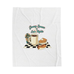 May include: A set of three ceramic mugs with a speckled, matte finish. The mugs are in shades of cream, light gray, and dark gray. Each mug has a simple, minimalist design and a rounded handle.