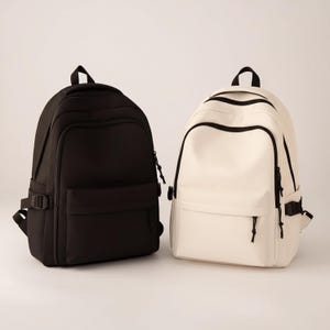 Mochila de nailon negro sólido de gran capacidad para estudiantes de secundaria y preparatoria: bolsa de viaje duradera y elegante.