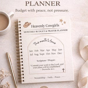 May include: A spiral-bound monthly budget planner with the text "Faith-Based MONTHLY BUDGET PLANNER". The planner includes the text "Heavenly Cowgirls" and "Monthly Budget & Prayer Planner". A gold pen and a cup of coffee are next to the planner.