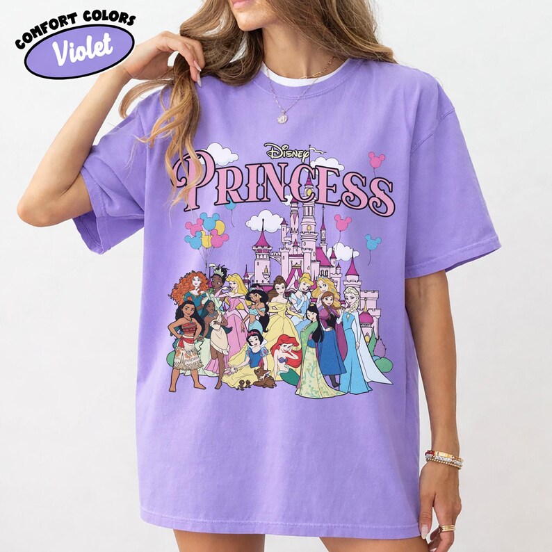 May include: A white ceramic mug with a black handle and the text "But First, Coffee" in a bold, black font. The mug is set against a blurred background, suggesting a cozy setting.