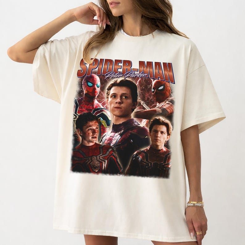 May include: Cream-colored t-shirt featuring a graphic of Spider-Man with the text "Spider-Man Peter Parker." The design includes multiple images of the character in his costume. The shirt has short sleeves and a relaxed fit.