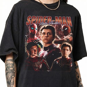 May include: Dark gray t-shirt featuring a collage of Spider-Man images and the text "SPIDER-MAN Peter Parker" in a retro style. The design includes multiple images of Spider-Man in his suit.