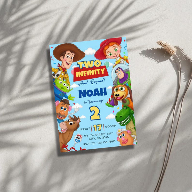 May include: A light blue birthday invitation card featuring Toy Story characters including Woody, Jessie, Buzz Lightyear, Rex, and Mr. Potato Head. The text reads: TWO INFINITY And Beyond! NOAH is turning 2, August 17, 5:00 PM, 123 TOY STREET, ANY CITY, CA 12345, RSVP TO: 123 456 7890.