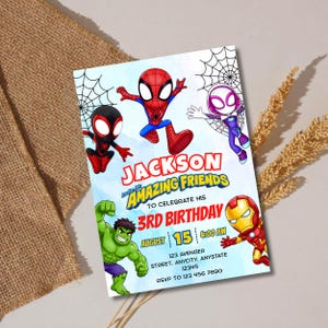 May include: A rectangular birthday invitation card featuring cartoon illustrations of Spider-Man, Ghost-Spider, Miles Morales, Hulk, and Iron Man. The text reads: JACKSON AND HIS AMAZING FRIENDS TO CELEBRATE HIS 3RD BIRTHDAY, AUGUST 15, 4:00 PM, 123 AVENGER STREET.