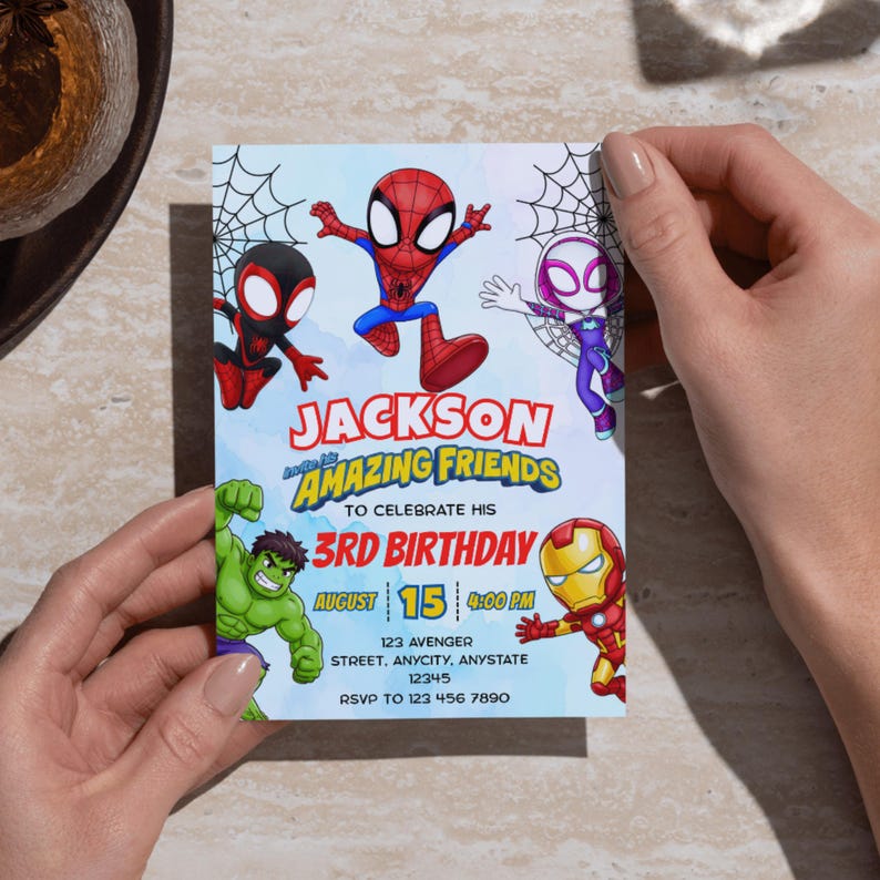 May include: A rectangular birthday invitation card featuring cartoon illustrations of Spider-Man, Ghost-Spider, Miles Morales, Hulk, and Iron Man. The text reads: JACKSON AND HIS AMAZING FRIENDS TO CELEBRATE HIS 3RD BIRTHDAY, AUGUST 15, 4:00 PM, 123 AVENGER STREET.