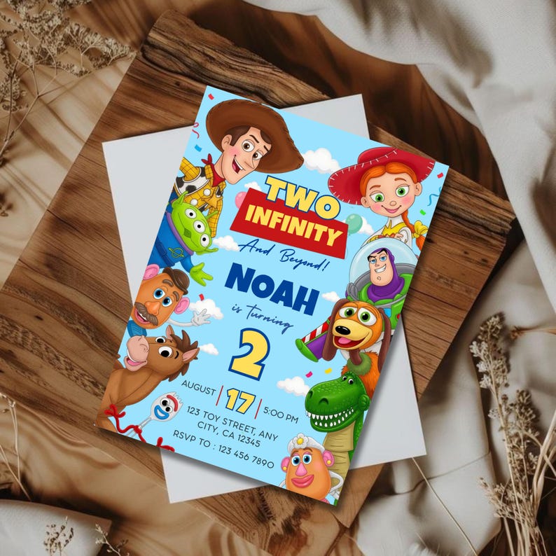 May include: A light blue birthday invitation card featuring cartoon characters including a cowboy, cowgirl, space ranger, green dinosaur, and potato figures. The text reads: TWO INFINITY And Beyond! NOAH is turning 2 AUGUST 17 5:00 PM.