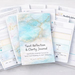 May include: A Tarot Reflection & Clarity Journal with a watercolor-style cover in shades of blue and gold. The journal is surrounded by open pages with prompts and spaces for notes. The text on the cover reads "Tarot Reflection & Clarity Journal".