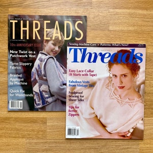 May include: Two copies of Threads magazine, a sewing magazine. The cover of the first magazine features a woman wearing a patchwork vest. The cover of the second magazine features a woman wearing a white lace collar. The text on the covers reads "Threads" and "Sewing-Machine Care Patterns: What's New?"