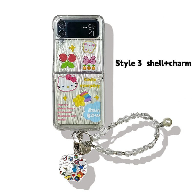 Peut inclure: Coque de t&eacute;l&eacute;phone transparente orn&eacute;e de motifs de dessins anim&eacute;s, dont des cerises, un n&oelig;ud et Hello Kitty. Elle est accompagn&eacute;e d'une dragonne en perles et d'un charm en forme de c&oelig;ur avec des personnages de dessins anim&eacute;s. Le texte "Smile everyday" et "Rain Bow" sont visibles.