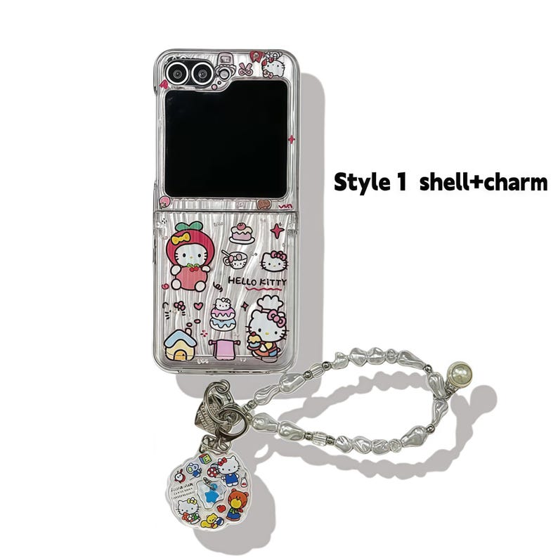 Peut inclure: Coque de t&eacute;l&eacute;phone transparente avec des graphismes Hello Kitty et un charm assorti. L'&eacute;tui pr&eacute;sente un design &agrave; rabat et comprend une dragonne perl&eacute;e. Le texte "Style 1 shell+charm" est visible.