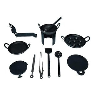 May include: A collection of small, black cookware and utensils. Includes a wok with a stand, pans with handles, a griddle, a spatula, tongs, a knife, and a slotted spoon. The set is designed for miniature cooking.