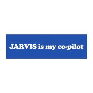 May include: A rectangular blue sticker featuring the white text "JARVIS is my co-pilot" in a bold, rounded, sans-serif typeface. The design is centred on a solid blue background, creating a clear contrast between the white lettering and the blue.