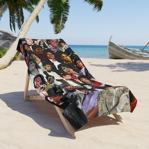 May include: A rectangular beach towel featuring a collage of various photographic portraits of Michael Jackson in different outfits, poses, and eras, printed in full color across the entire surface of the fabric draped over a wooden lounge chair.