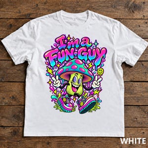 May include: A white t-shirt featuring a colorful graphic of a smiling mushroom character with arms and legs, wearing sneakers and making peace signs. The text "I'm a FUN-GUY" appears above the character in a vibrant, dripping font style.