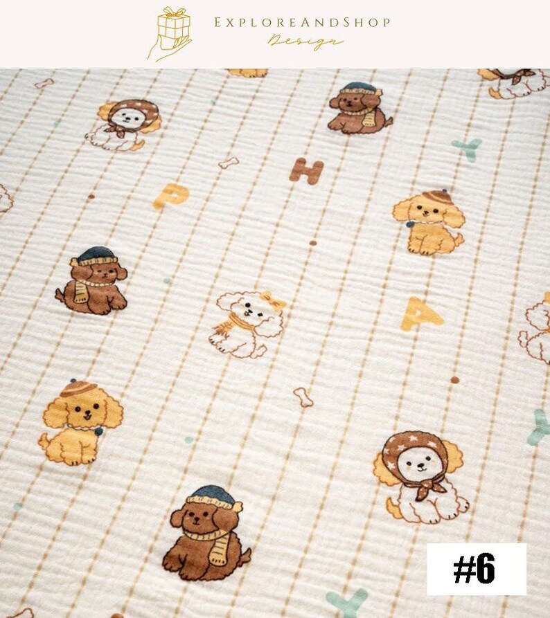May include: A cream-colored fabric with a repeating pattern of cartoon dogs wearing hats and scarves. The dogs are brown, tan, and white. The fabric also features the letters "H" and "A", along with bone and crossbone shapes. The text "#6" is in the bottom right corner.