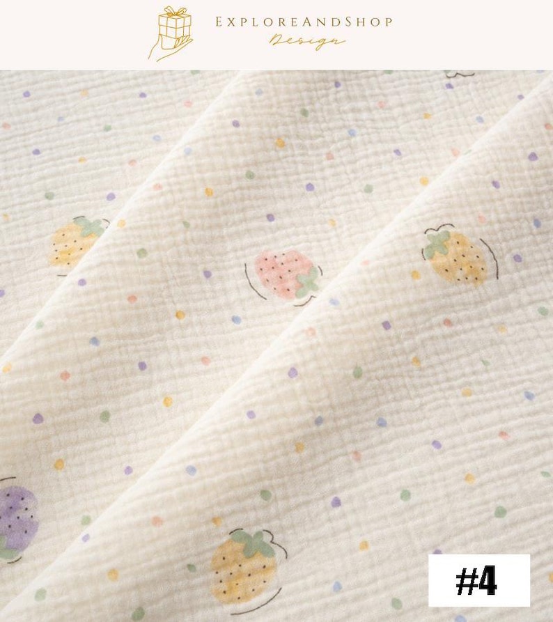 May include: Cream-colored fabric with a repeating pattern of strawberries and colorful polka dots. The strawberries are in various colors, including pink, yellow, and purple. The fabric has a textured appearance. The text "EXPLOREANDSHOP Design" is in the top right corner.