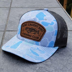 May include: A set of three ceramic nesting bowls in graduating sizes. The bowls feature a speckled, matte finish in shades of cream, beige, and brown. The largest bowl measures approximately 8 inches in diameter.