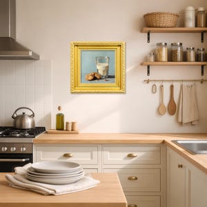 Hand painted oil painting of a glass of milk with chocolate chip cookies, displayed in a classic gold frame on a modern kitchen wall, perfect for tabletop display, kitchen wall decor, or gifting mom, wife, friend, foodie, or coffee lover, showcasing textured brushstrokes, realistic cookie details, and warm tones for breakfast inspired still life artwork.