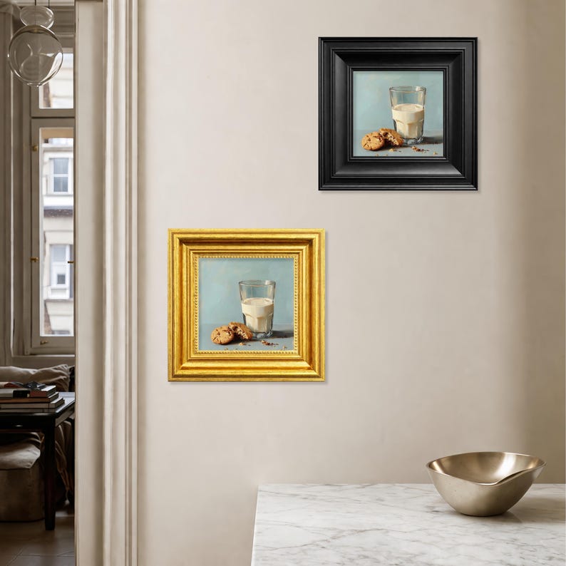 Small hand painted milk and cookie oil painting displayed as a combination of a sleek black frame and a classic gold frame on a kitchen wall, perfect for modern farmhouse decor, tabletop display, or gifting mom, wife, friend, foodie, or coffee lover, showcasing textured brushstrokes, realistic cookie details, and cozy breakfast inspired still life composition.