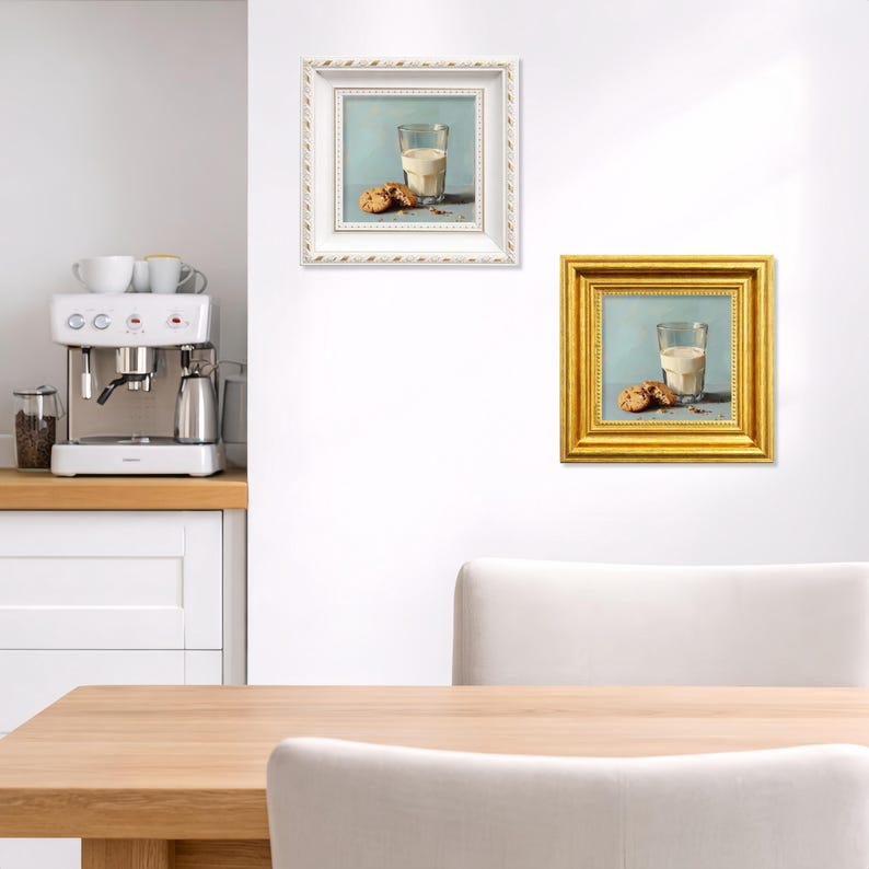 Miniature hand painted oil painting of a glass of milk with chocolate chip cookies, displayed as a combination of elegant white frame and classic gold frame on a bright kitchen wall, ideal for tabletop display, kitchen decor, or gifting mom, wife, friend, foodie, or coffee lover, highlighting handcrafted brushstrokes, realistic cookie textures, and cozy breakfast inspired composition.