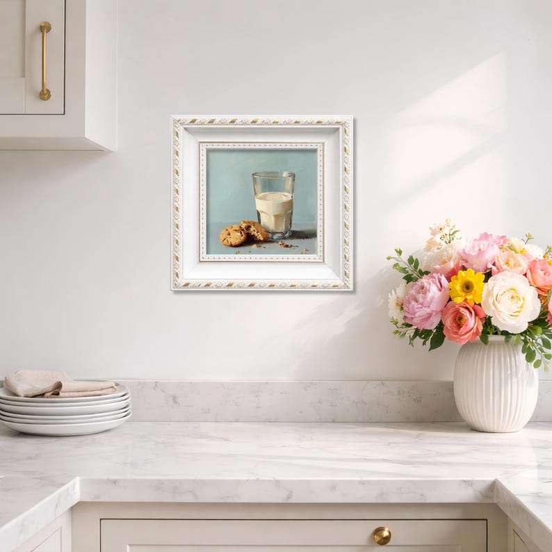 Small hand painted oil painting of a glass of milk and chocolate chip cookies, elegantly framed in white and displayed on a bright kitchen wall, perfect for home decor, tabletop display, or gifting mom, wife, friend, foodie, or coffee lover, showcasing textured brushstrokes, realistic cookie details, and soft warm tones to complement modern kitchen aesthetics.