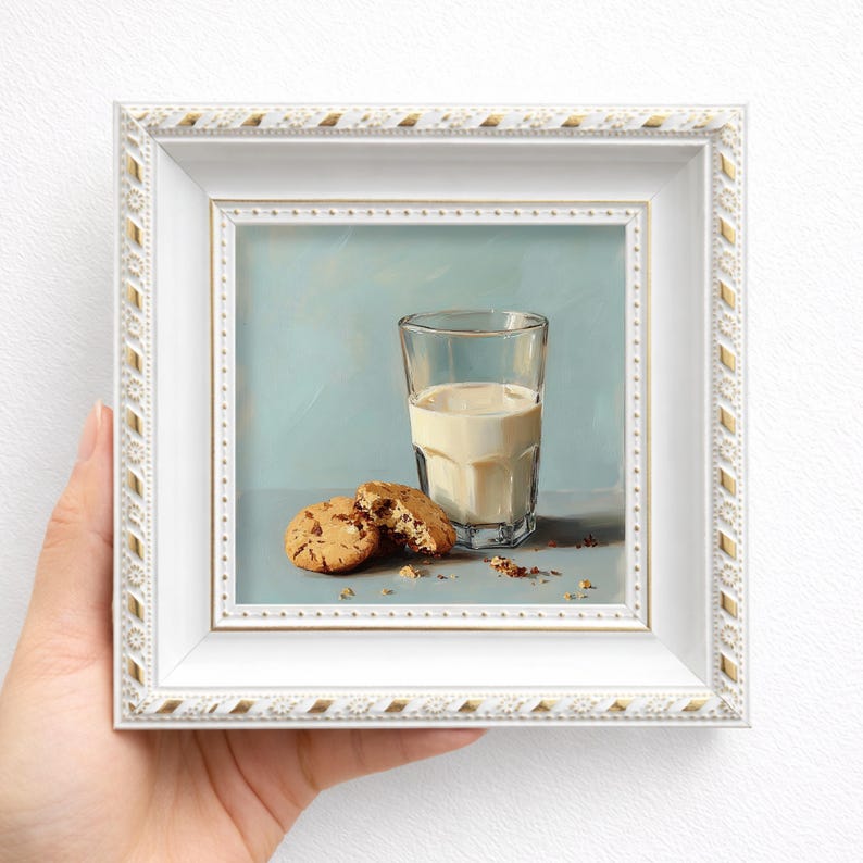 Miniature hand painted oil painting of milk and cookies, elegantly framed in white and held in hand, ideal for kitchen wall decor, tabletop display, or gifting mom, wife, friend, foodie, or coffee lover, showcasing realistic cookie textures, handcrafted brushstrokes, and warm soft tones for cozy breakfast inspired still life art.