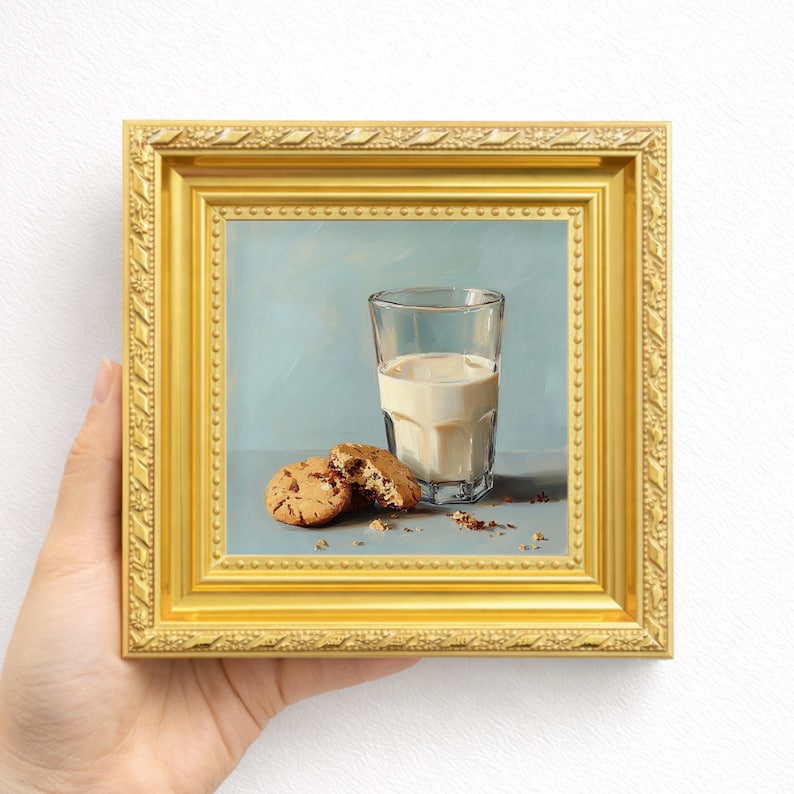 Hand painted oil painting featuring a glass of milk and chocolate chip cookies, displayed in a classic gold frame and held in hand, perfect for kitchen tabletop display, breakfast wall decor, or gifting mom, wife, friend, foodie, or coffee lover, showcasing textured brushstrokes, realistic cookie details, and warm soft tones for elegant breakfast inspired still life art.