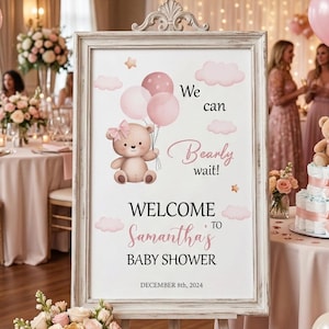 May include: A baby shower sign with a teddy bear illustration and the text "Welcome to Samantha's Baby Shower". The sign is on an easel, surrounded by balloons, flowers, and a teddy bear. The event date is December 8th, 2024.
