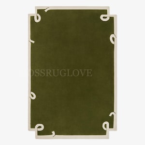 May include: A rectangular olive green rug with a cream-colored border. The rug features a unique design with white, curved shapes at each corner. The text "MOSSRUGLOVE" is visible on the rug.
