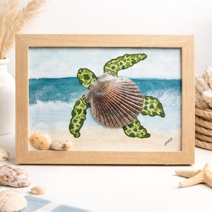 May include: Framed artwork of a sea turtle. The turtle's shell is a large, textured seashell, with green and brown painted flippers. The background shows a beach scene with blue ocean waves and sand. The frame is made of wood.