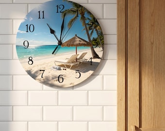 May include: A round wall clock featuring a tropical beach scene with white sand, turquoise water, palm trees, and a thatched umbrella over two lounge chairs. The clock face displays black Arabic numerals from 1 to 12 and black hour and minute hands.