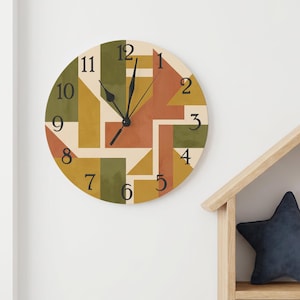 May include: A round wall clock featuring a geometric pattern in shades of olive green, mustard yellow, terracotta, and cream. The clock face displays black serif numerals from one to twelve and includes three black hands for hour, minute, and second.