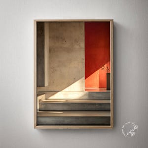 Pode incluir: Impressão de arte emoldurada com um interior arquitetônico com escadas e paredes de concreto. Uma parede vermelha vibrante contrasta com os tons neutros do concreto, e a luz do sol ilumina a cena. Um vaso com plantas secas é visível.