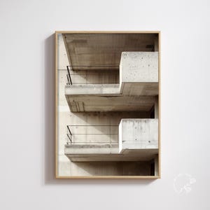 May include: A framed print featuring a concrete architectural design. The image showcases a series of cantilevered balconies with black railings. The neutral color palette of the concrete and the wooden frame creates a modern aesthetic.