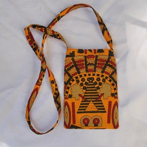 May include: A small yellow, red, and black patterned crossbody bag with a long strap.