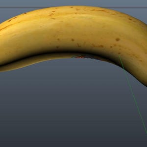 May include: A single ripe banana, yellow with brown speckles, is shown against a grey backdrop. The banana has a curved shape and a darker yellow stem. The image is a studio shot of the fruit.