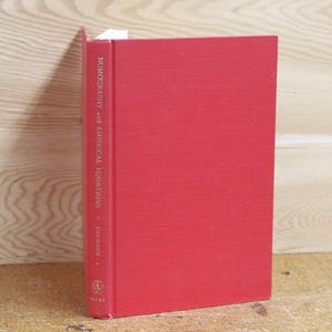 May include: A red hardcover book titled "Nomography and Empirical Equations" by D.S. Davis. The book is published by Wiley.