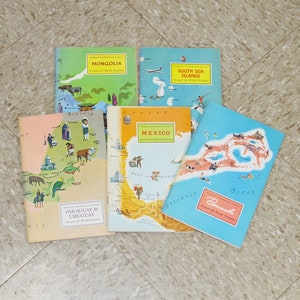 May include: Five colorful illustrated travel brochures with maps of different countries and regions. The brochures are titled "Mongolia", "South Sea Islands", "Mexico", "Paraguay & Uruguay", and "Bermuda".