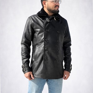May include: A black leather pea coat with a faux fur collar. The double-breasted jacket features large, round buttons and adjustable straps on the sleeves. The coat is worn with blue jeans.